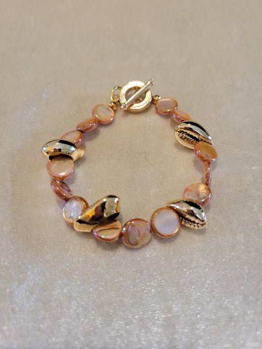 Gold/Orange dyed shells with gold tone cowrie shaped focal, size 7.5