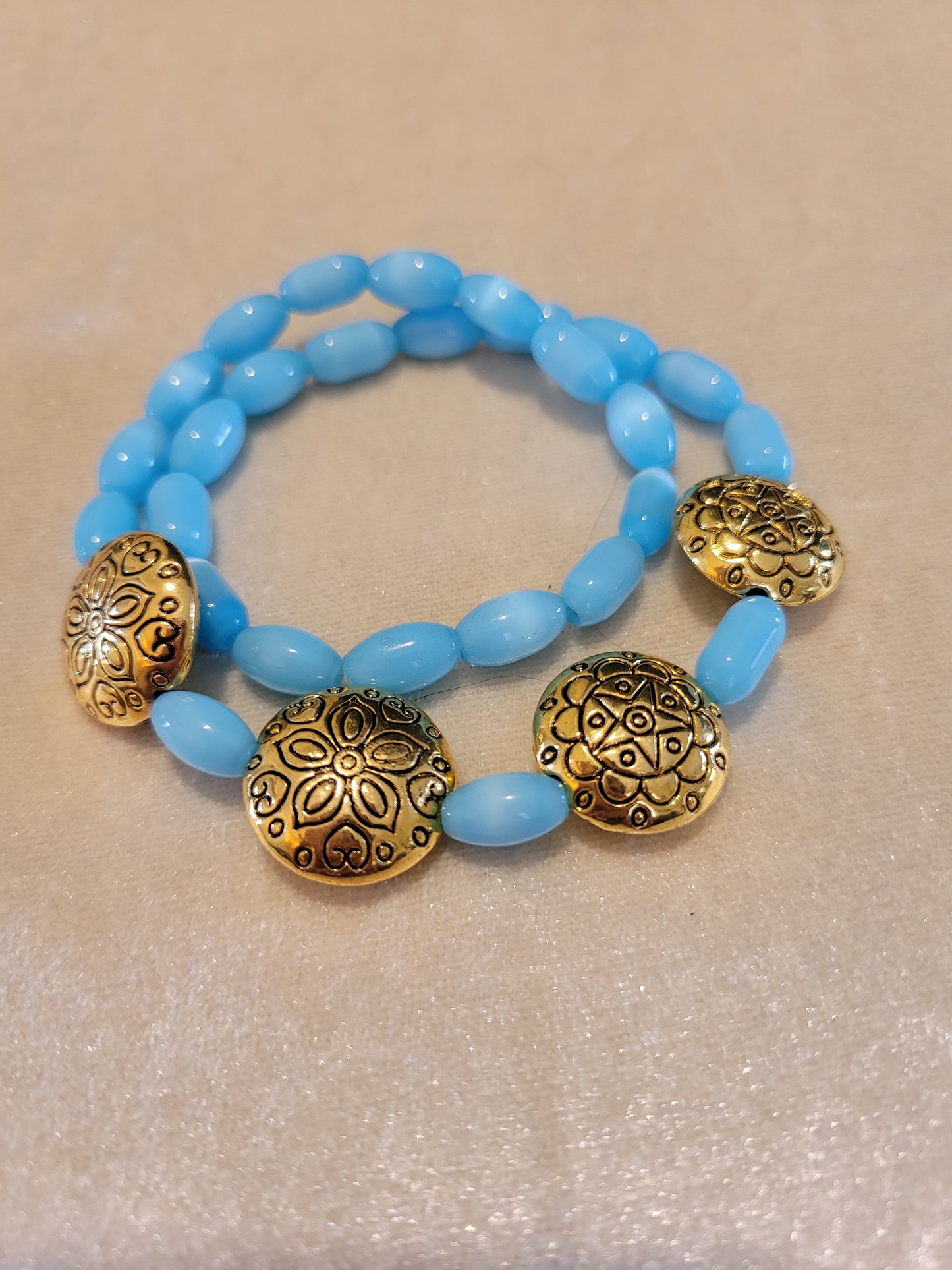 Light blue cat eye stretch bracelet with gold puffed beads,14 inches