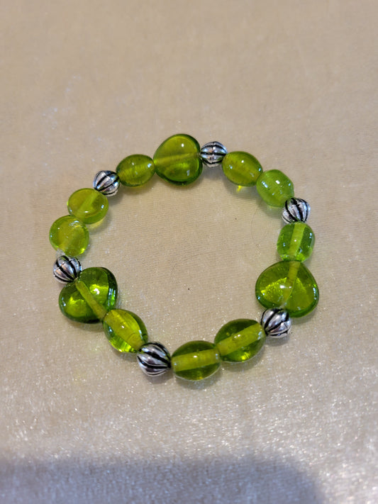 Green glass beads with silver tone acrylic spacers, stretch bracelet