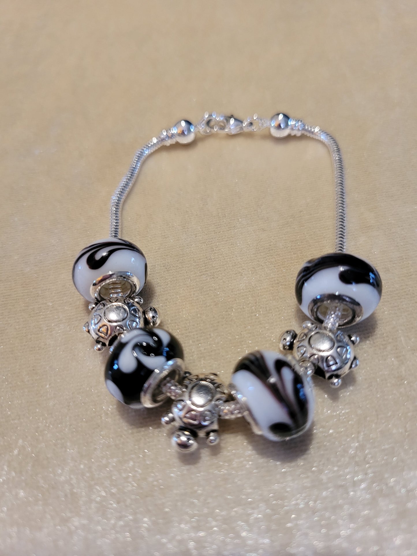 Silver tone bracelet with black and white Dione beads, size 8